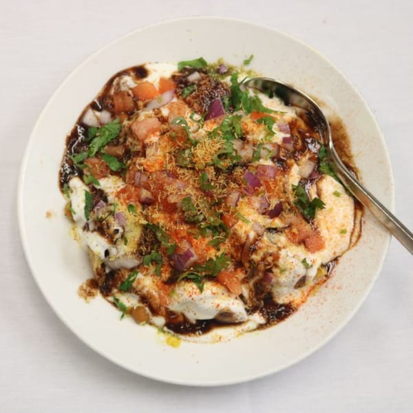 Himalayan Doko's Indian chaat, topped with yogurt, chutneys, chopped onions, tomatoes, and spices.